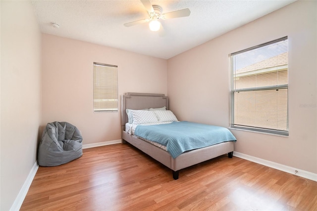 16828 N Gold Star Ct, Clermont, FL 34714 - bedroom with light wood finished floors and ceiling fan