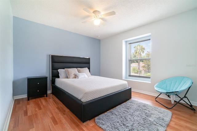 16828 N Gold Star Ct, Clermont, FL 34714 - bedroom featuring light wood finished floors, a ceiling fan, and a textured ceiling