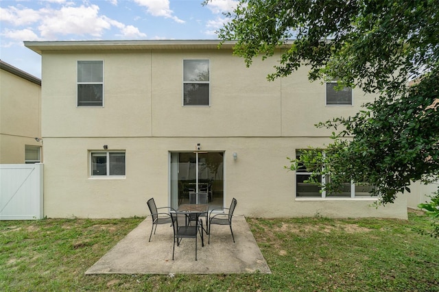 16828 N Gold Star Ct, Clermont, FL 34714 - rear view of property featuring stucco siding and a patio