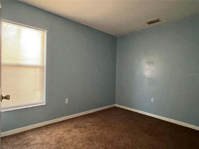 103 Thornbush Pkwy, Davenport, FL 33837 - spare room with dark colored carpet and baseboards