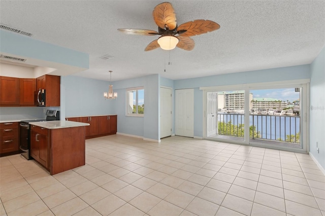 14800 Walsingham Rd Unit 1215, Largo, FL 33774 - kitchen with appliances with stainless steel finishes, light countertops, a chandelier, a ceiling fan, and brown cabinetry
