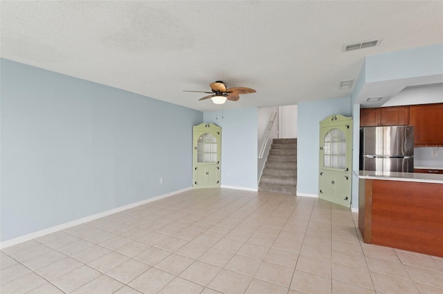 14800 Walsingham Rd Unit 1215, Largo, FL 33774 - unfurnished living room with stairway, ceiling fan, and light tile patterned floors