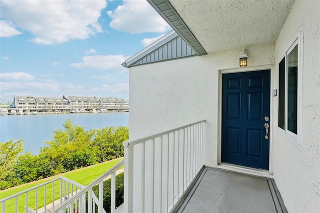 14800 Walsingham Rd Unit 1215, Largo, FL 33774 - entrance to property featuring stucco siding, a water view, and a balcony