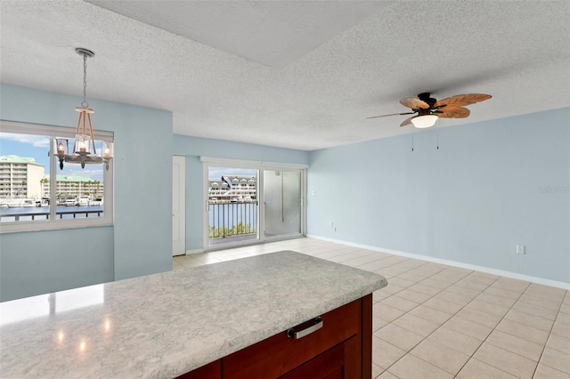 14800 Walsingham Rd Unit 1215, Largo, FL 33774 - kitchen featuring ceiling fan, a chandelier, pendant lighting, light countertops, and a textured ceiling