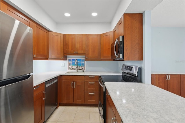14800 Walsingham Rd Unit 1215, Largo, FL 33774 - kitchen featuring appliances with stainless steel finishes, light tile patterned flooring, brown cabinetry, and recessed lighting