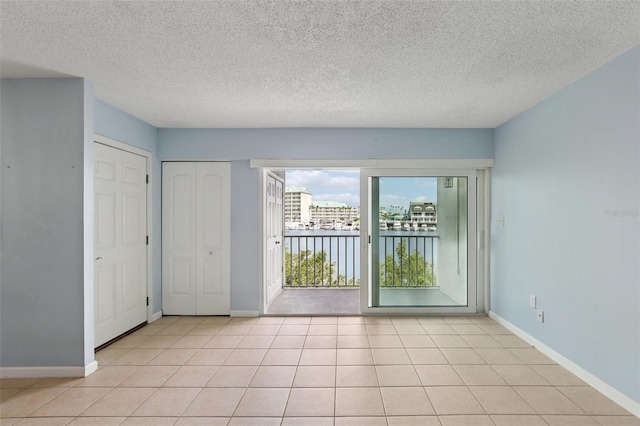 14800 Walsingham Rd Unit 1215, Largo, FL 33774 - empty room featuring a textured ceiling and light tile patterned floors