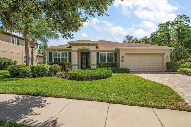 19409 Wingrove Ln, Lutz, FL 33558 - mediterranean / spanish-style house with stucco siding, an attached garage, decorative driveway, and a front lawn
