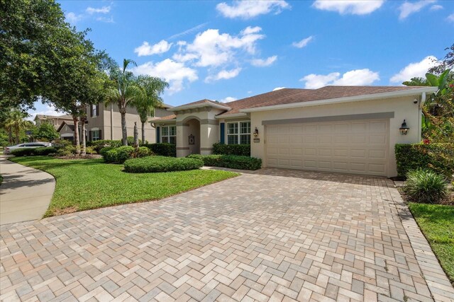 19409 Wingrove Ln, Lutz, FL 33558 - view of front facade with stucco siding, decorative driveway, a front yard, and a garage
