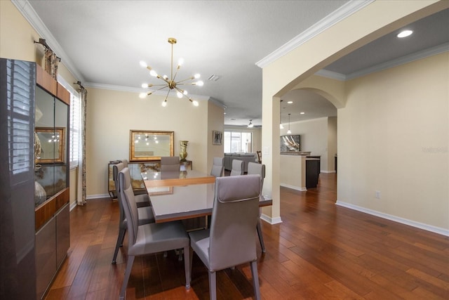 19409 Wingrove Ln, Lutz, FL 33558 - dining area featuring ornamental molding, a chandelier, arched walkways, and dark wood-style flooring