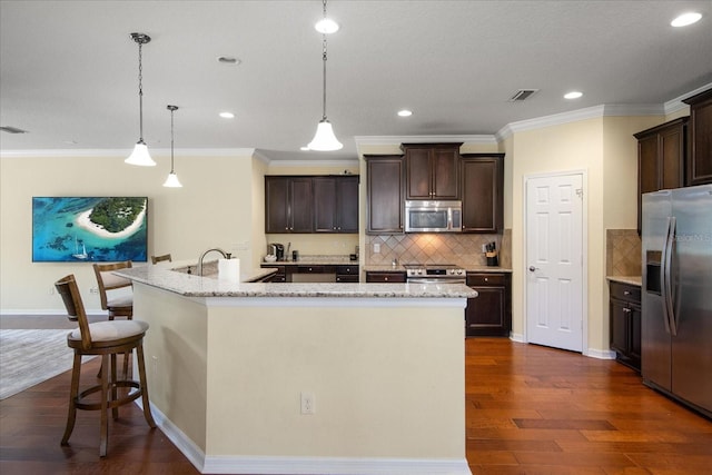 19409 Wingrove Ln, Lutz, FL 33558 - kitchen featuring stainless steel appliances, a large island, dark wood-style flooring, tasteful backsplash, and recessed lighting