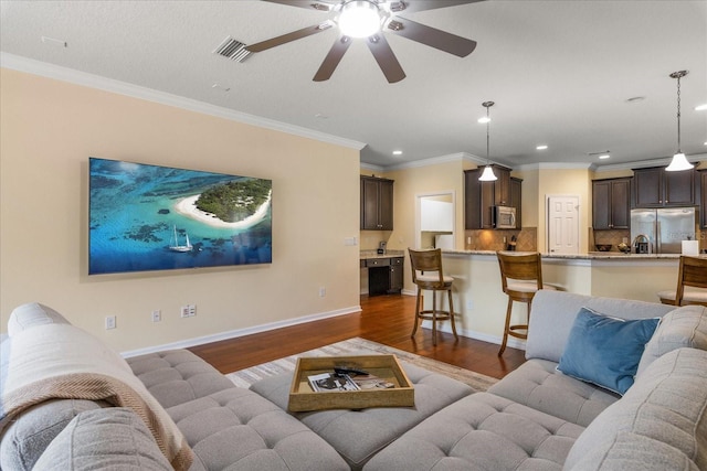 19409 Wingrove Ln, Lutz, FL 33558 - living area with recessed lighting, wood finished floors, ceiling fan, and crown molding