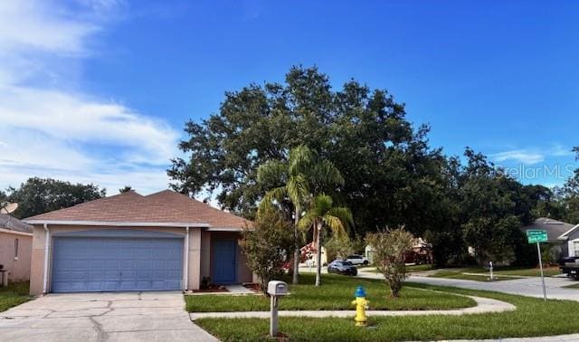 11022 Connacht Way, Tampa, FL 33610 - view of front of house featuring concrete driveway, an attached garage, stucco siding, and a front yard