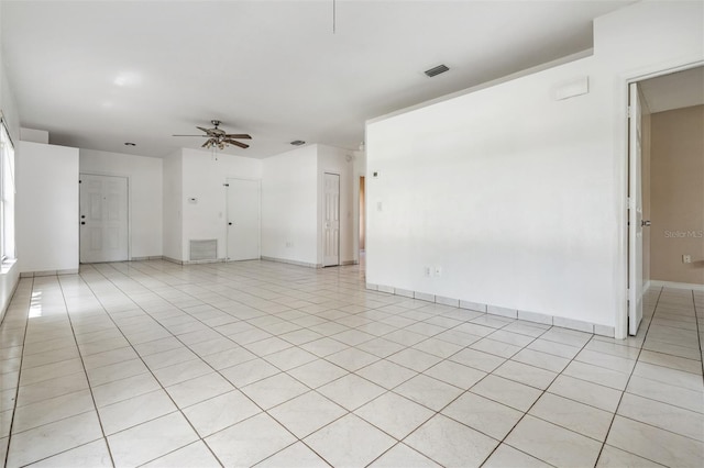 11022 Connacht Way, Tampa, FL 33610 - unfurnished living room with ceiling fan and light tile patterned flooring