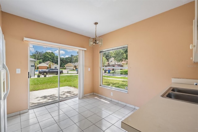 11022 Connacht Way, Tampa, FL 33610 - unfurnished dining area featuring a chandelier and light tile patterned flooring