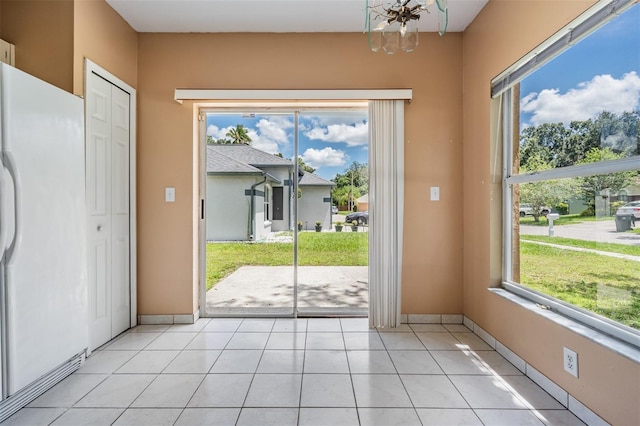 11022 Connacht Way, Tampa, FL 33610 - doorway to outside featuring a chandelier and light tile patterned floors
