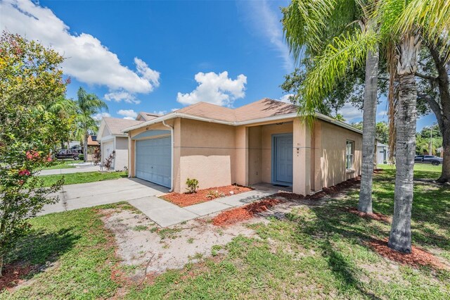 11022 Connacht Way, Tampa, FL 33610 - ranch-style house with stucco siding, concrete driveway, a garage, and a front lawn
