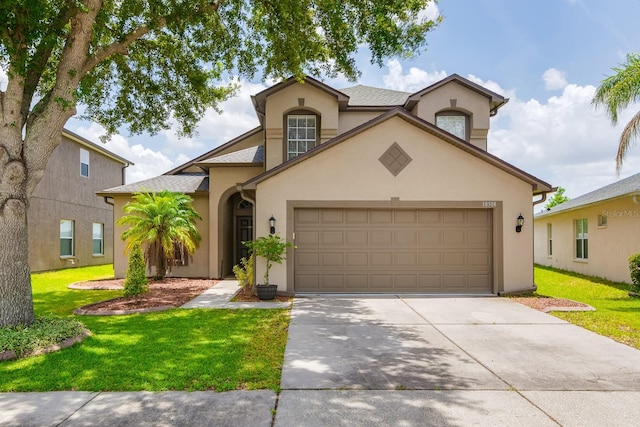 18508 Merseyside Loop, Land O Lakes, FL 34638 - view of front of house with stucco siding, driveway, a garage, and a front yard