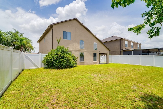 18508 Merseyside Loop, Land O Lakes, FL 34638 - rear view of house with a fenced backyard and stucco siding