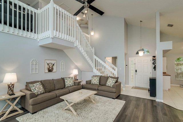 18508 Merseyside Loop, Land O Lakes, FL 34638 - living room featuring high vaulted ceiling, stairway, a ceiling fan, and wood finished floors