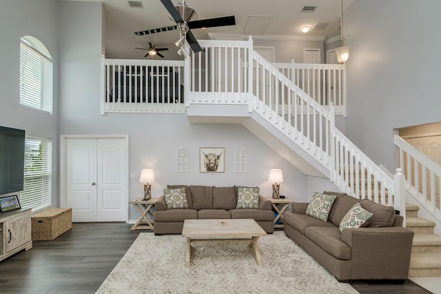 18508 Merseyside Loop, Land O Lakes, FL 34638 - living area featuring a ceiling fan, a towering ceiling, dark wood-style flooring, ornamental molding, and stairway
