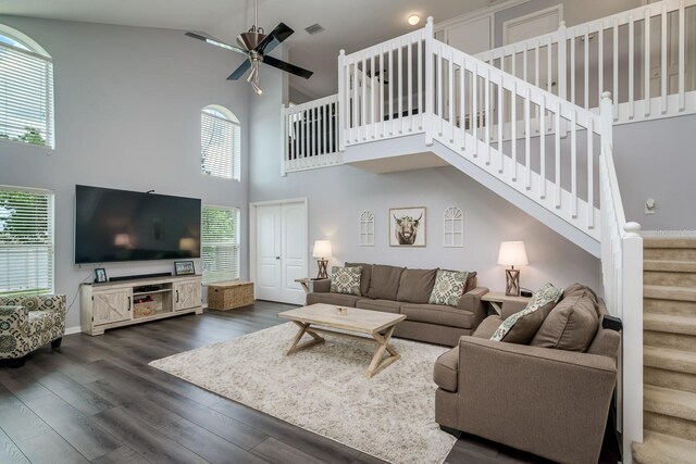 18508 Merseyside Loop, Land O Lakes, FL 34638 - living area featuring high vaulted ceiling, stairway, a ceiling fan, and dark wood-type flooring