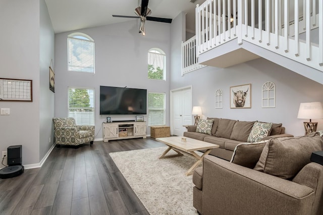 18508 Merseyside Loop, Land O Lakes, FL 34638 - living area featuring a high ceiling, ceiling fan, plenty of natural light, dark wood finished floors, and stairway