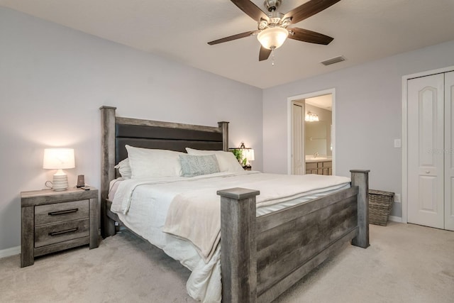 18508 Merseyside Loop, Land O Lakes, FL 34638 - bedroom with light carpet, connected bathroom, and ceiling fan
