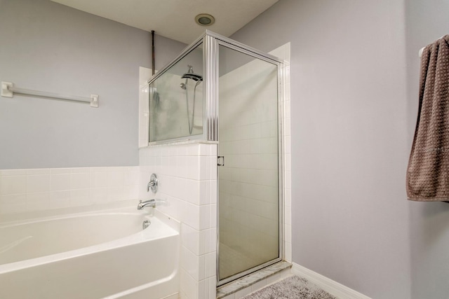 18508 Merseyside Loop, Land O Lakes, FL 34638 - bathroom featuring a bath and a stall shower