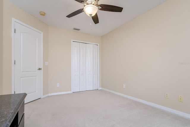 18508 Merseyside Loop, Land O Lakes, FL 34638 - unfurnished bedroom featuring light carpet, a closet, and a ceiling fan