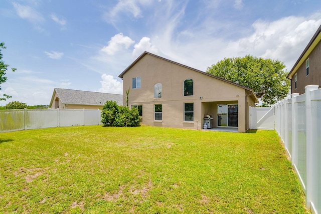 18508 Merseyside Loop, Land O Lakes, FL 34638 - rear view of property with stucco siding and a fenced backyard