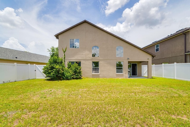 18508 Merseyside Loop, Land O Lakes, FL 34638 - rear view of property featuring a fenced backyard, stucco siding, and a patio area