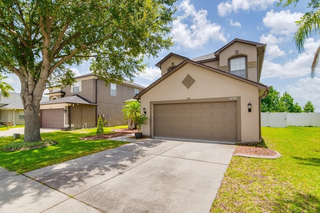 18508 Merseyside Loop, Land O Lakes, FL 34638 - view of front facade with stucco siding, concrete driveway, and a garage