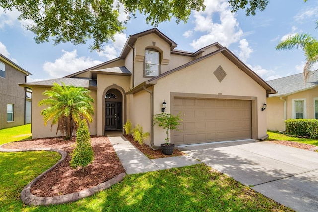 18508 Merseyside Loop, Land O Lakes, FL 34638 - view of front of home with an attached garage, stucco siding, concrete driveway, and a front lawn