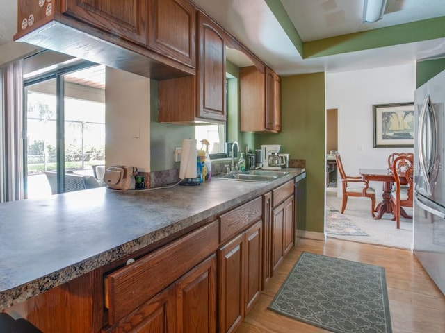 1610 Sanderling Ct, Brandon, FL 33511 - kitchen featuring stainless steel appliances, plenty of natural light, dark countertops, and brown cabinetry