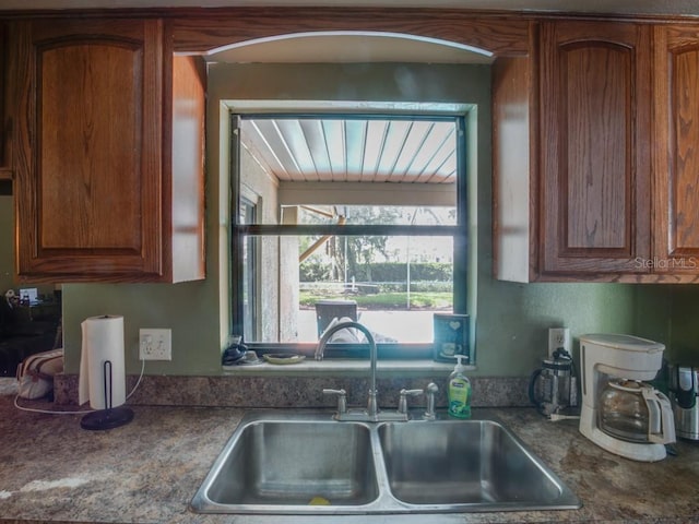 1610 Sanderling Ct, Brandon, FL 33511 - kitchen featuring brown cabinetry and dark countertops