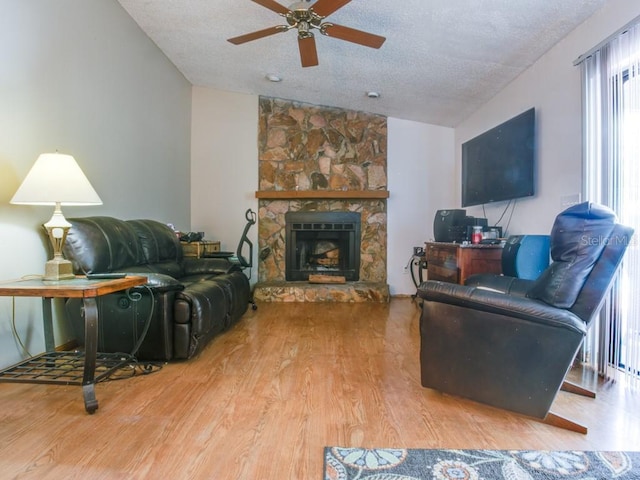 1610 Sanderling Ct, Brandon, FL 33511 - living area featuring vaulted ceiling, wood finished floors, a ceiling fan, a textured ceiling, and a fireplace
