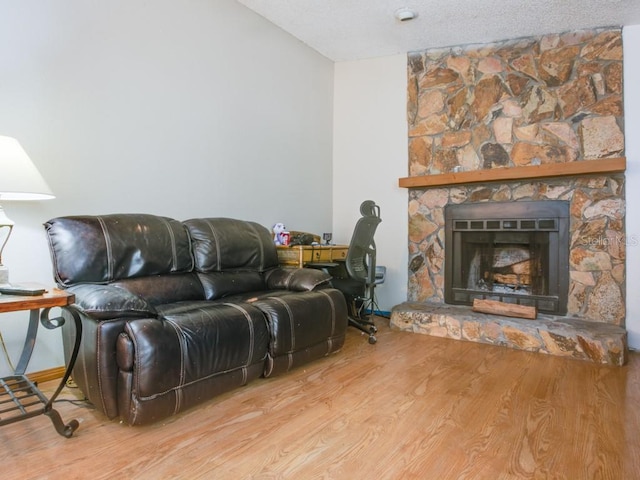 1610 Sanderling Ct, Brandon, FL 33511 - living room featuring wood finished floors, a stone fireplace, and a textured ceiling