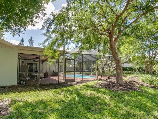 1610 Sanderling Ct, Brandon, FL 33511 - swimming pool featuring a lawn, ceiling fan, and a patio area