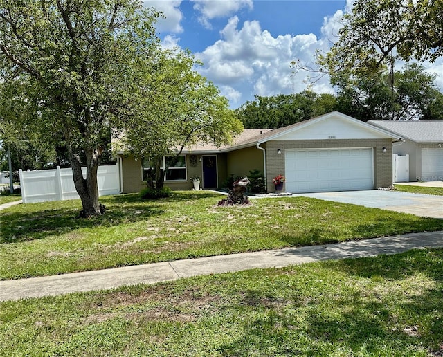 7301 Mitchell Ranch Rd, New Port Richey, FL 34655 - view of front of property featuring a garage, driveway, and brick siding