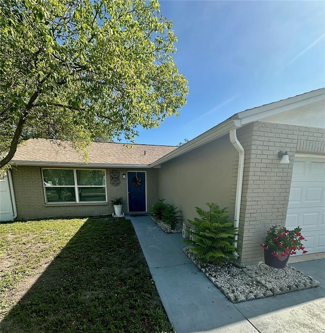 7301 Mitchell Ranch Rd, New Port Richey, FL 34655 - view of front of home with brick siding, a garage, and a front lawn
