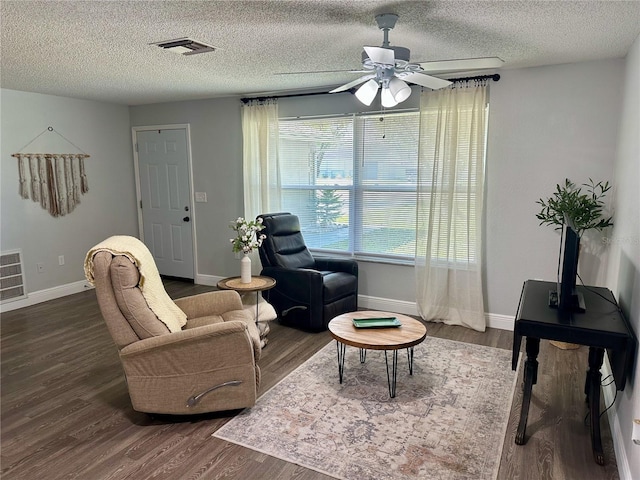 7301 Mitchell Ranch Rd, New Port Richey, FL 34655 - living room featuring dark wood-type flooring, ceiling fan, and a textured ceiling