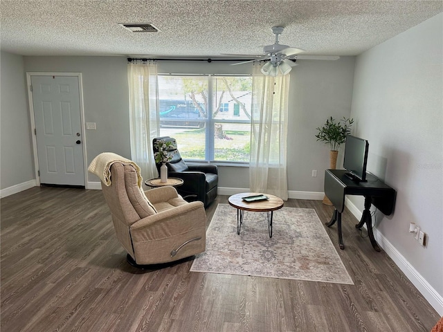 7301 Mitchell Ranch Rd, New Port Richey, FL 34655 - living area with dark wood-style flooring, a ceiling fan, and a textured ceiling