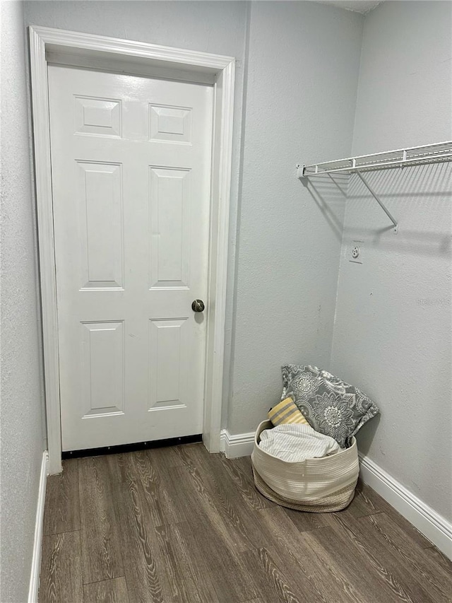 7301 Mitchell Ranch Rd, New Port Richey, FL 34655 - laundry room with dark wood-style flooring