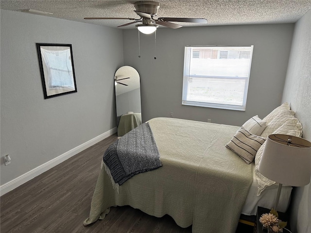 7301 Mitchell Ranch Rd, New Port Richey, FL 34655 - bedroom featuring dark wood finished floors, a textured ceiling, and ceiling fan