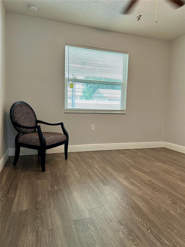 7301 Mitchell Ranch Rd, New Port Richey, FL 34655 - unfurnished room with dark wood-type flooring, a ceiling fan, and a textured ceiling