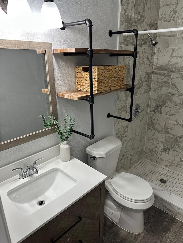 7301 Mitchell Ranch Rd, New Port Richey, FL 34655 - bathroom featuring a stall shower, vanity, wood finished floors, and a textured wall