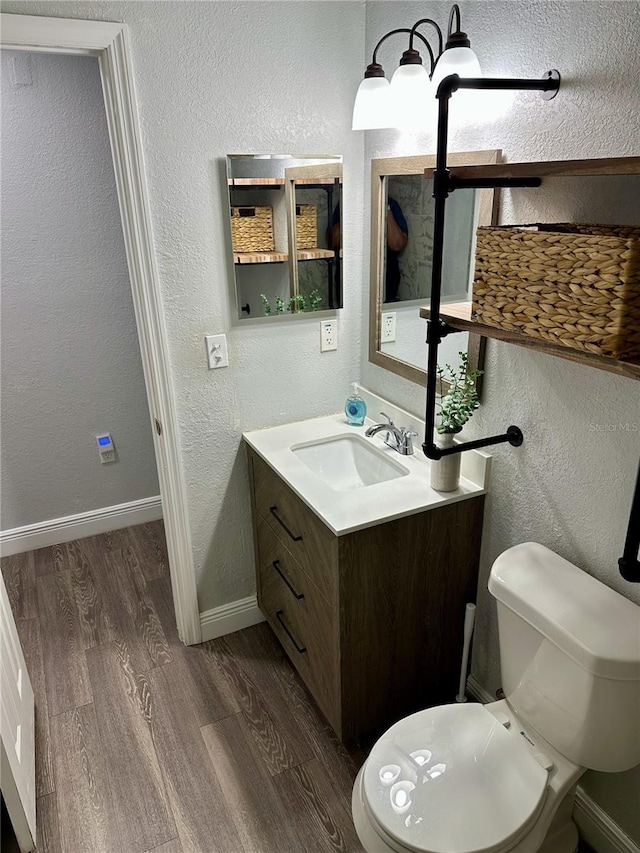 7301 Mitchell Ranch Rd, New Port Richey, FL 34655 - half bath with wood finished floors, vanity, and a textured wall