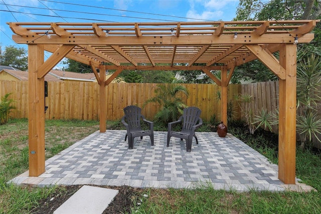 245 Grove Cir N, Dunedin, FL 34698 - fenced backyard with a patio area and a pergola
