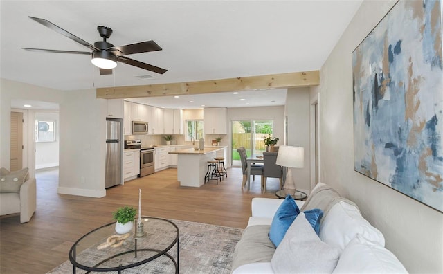 245 Grove Cir N, Dunedin, FL 34698 - living area with ceiling fan and light wood-type flooring
