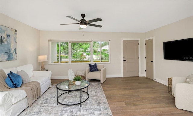 245 Grove Cir N, Dunedin, FL 34698 - living area with a ceiling fan and wood finished floors